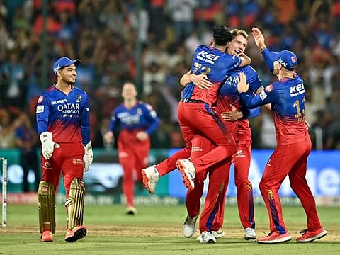 Royal Challengers Bengaluru's Cameron Green celebrates with teammates after taking the wicket of Delhi Capitals' Tristan Stubbs during the Indian Premier League (IPL) match at the M Chinnaswamy Stadium in Bengaluru on Sunday.