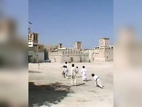 Still from video posted on social media by Dubai Media Office showing archive footage of an old area of Dubai, lined with traditional houses featuring wind towers used to cool homes before modern air-conditioning  