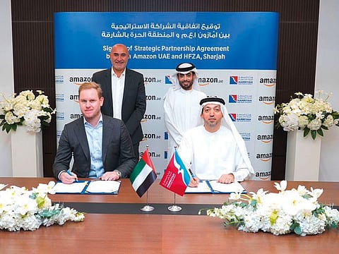 Officials from Hamriyah Free Zone Authority and Amazon UAE sign the lease for a new logistics centre