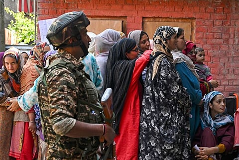 Voters queue up to cast their ballots at a polling station during the fourth phase of voting in Indias general election, in Srinagar on May 13, 2024.  