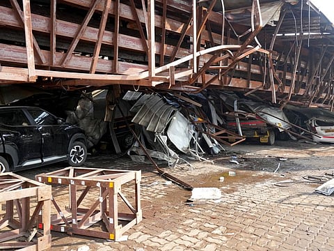 Vehicles are trapped under the debris after a massive billboard fell during a rainstorm in Mumbai on May 14, 2024.  