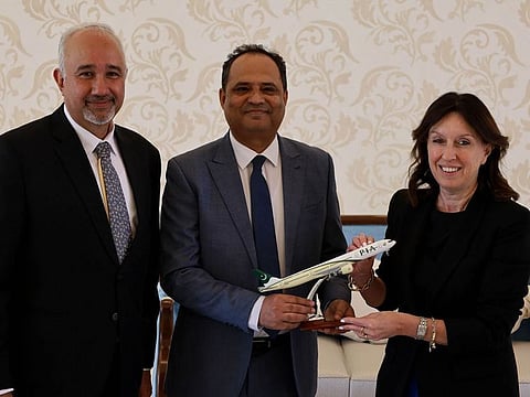 Pakistan Ambassador Faisal Niaz Trimzi (from Left) and Tariq Gulzar, Area Manager PIA while presenting a PIA model plane to CEO Abu Dhabi Airports Elena Sorlini at Al Ain International Airport.