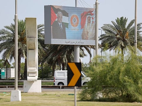 A billboard displays photos of Bahrain's King Hamad bin Eisa Al Khalifa and Palestinian President Mahmoud Abbas with logo of the 33rd Arab Summit that will take place in Manama on May 16, 2024.  
