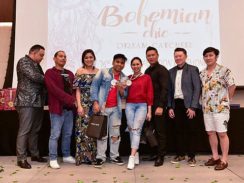 Kenneth Farley De Villa and his ballroom dance partner, holding their medals, together with the judges and board members at a dance competition back in April 2019, in Dubai.  
