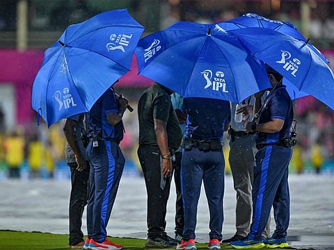Field umpires and other officials talk with each other as rain delays the start of the Indian Premier League (IPL) Twenty20 cricket match between Rajasthan Royals and Kolkata Knight Riders at the Barsapara Cricket Stadium in Guwahati on Sunday.