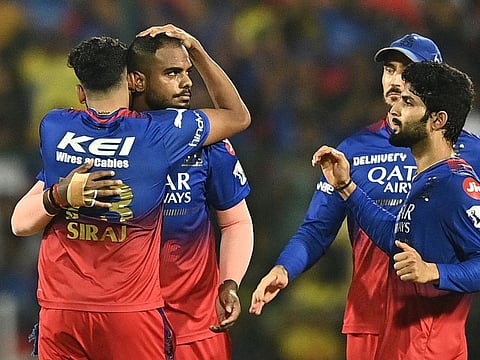 Royal Challengers Bengaluru’s players celebrate after Yash Dayal (second left) dismissed Chennai Super Kings’ MS Dhoni during the Indian Premier League cricket match on May 18, 2024. Dayal conceded only 7 runs in his final over to craft RCB’s victory. 