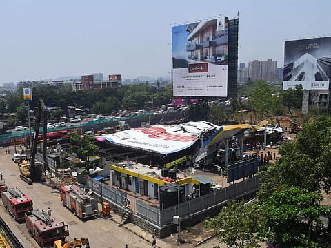 Emergency vehicles are seen parked at the site a day after an advertisement billboard collapsed over a petrol station following a storm, in Mumbai on May 14, 2024. Police in India's financial capital have opened a criminal case against the owner of a huge billboard that collapsed on a petrol station and killed 14 people, media reports said on May 14. The giant 70 by 50-metre (230 by 164-foot) hoarding in Mumbai's east collapsed on May 13 as fierce winds buffeted the city, accompanied by rain and dust storms. 