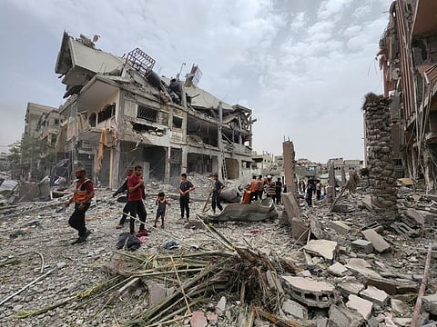 Palestinians inspect the site of an Israeli strike on a house, amid the ongoing conflict between Israel and the Palestinian Islamist group Hamas, in Beit Lahia, in the northern Gaza Strip, oj May 20, 2024. 