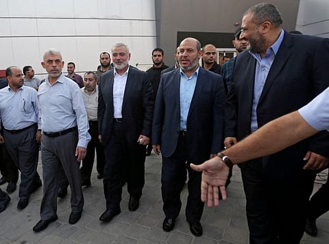 Hamas Gaza Chief Yahya Sinwar, (second left) Hamas Chief Ismail Haniyeh and senior Hamas leader Khalil al Hayya arrive at the Rafah border crossing in the southern Gaza Strip September 19, 2017.  