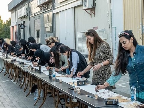 Watch: 41 artists ‘brew up’ 70-metre painting with coffee in live Dubai event