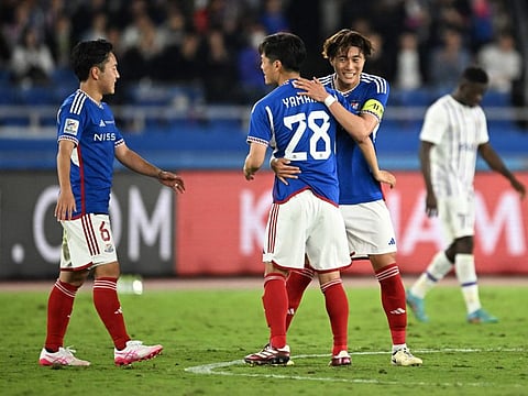 Yokohama's Japanese player Kota Watanabe (L), midfielder Riku Yamane (C) and player Takuya Kida (2nd R) celebrate their victory during the AFC Champions League final first leg football match between UAE's Al Ain and Japan's Yokohama F. Marinos at Nissan Stadium in Yokohama, Kanagawa prefecture, south of Tokyo, on May 11, 2024. (Photo by Philip FONG / AFP)