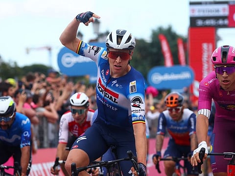 Team Soudal-Quick Step's Belgian rider Tim Merlier celebrates as he crosses the finish line to win the 18th stage of the 107th Giro d'Italia cycling race, 178km between Fiera di Primiero and Padua on Thursday.