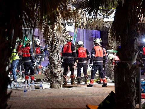 Emergency staff's members work after a two-storey building collapsed, on Playa de Palma, south of the Spanish Mediterranean island's capital Palma de Mallorca, on May 23, 2024.  