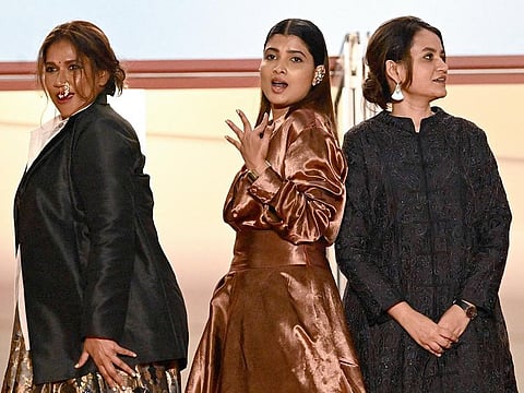 From left: Indian actress Chhaya Kadam, Indian actress Divya Prabha and Indian director Payal Kapadia arrive for the screening of the film "All We Imagine as Light" at the 77th edition of the Cannes Film Festival in Cannes, southern France, on May 23, 2024. 