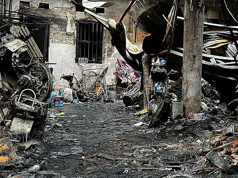 Charred belongings are seen outside a burnt house following a large fire at an apartment block in Hanoi on May 24, 2024.
