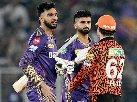 Kolkata Knight Riders' captain Shreyas Iyer (C) and Venkatesh Iyer (L) are congratulated by Sunrisers Hyderabad's Travis Head after their team's win at the IPL first qualifier in the Narendra Modi Stadium of Ahmedabad on May 21, 2024. 