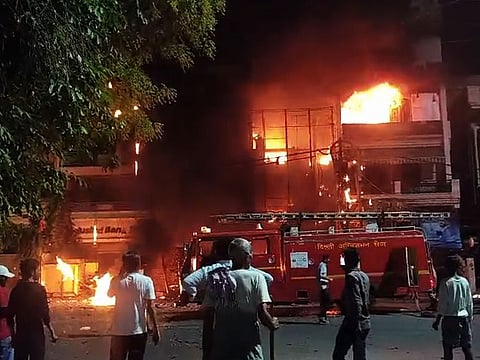 Firefighters attempt to douse the fire at a New Born Baby Care Hospital in Vivek Vihar, New Delhi on Saturday.  