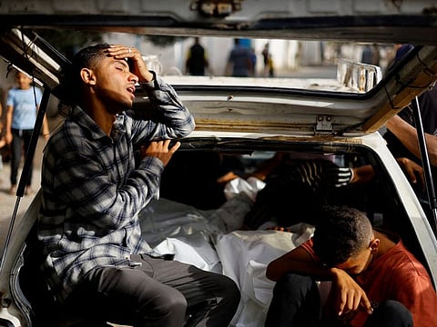 Mourners react next to the bodies of Palestinians killed in an Israeli strike on an area designated for displaced people, during their funeral in Rafah, in the southern Gaza Strip, May 27, 2024.  