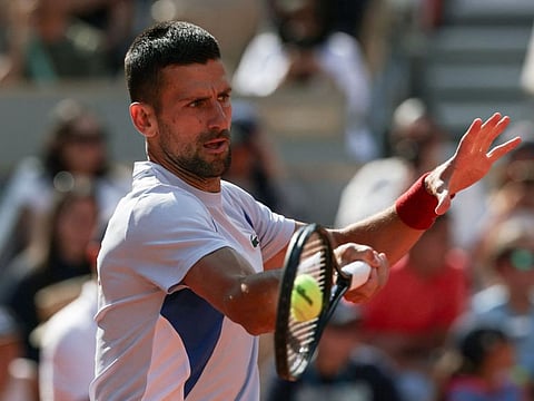 Serbia's Novak Djokovic takes part in a practice session during the French Open on Court Philippe-Chatrier at the Roland Garros Complex in Paris.