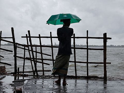 A man stands on the bank of Kholpetua river before the Cyclone Remal hits the country in the Shyamnagar area of Satkhira, Bangladesh.