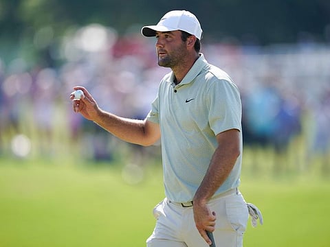 Scottie Scheffler of the United States acknowledges fans after a putt on the 18th green during the final round of the Charles Schwab Challenge at Colonial Country Club on May 26.