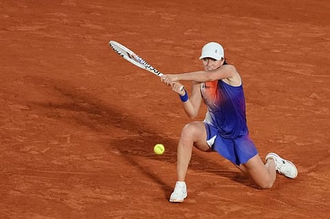 Poland's Iga Swiatek plays a backhand return to Japan's Naomi Osaka during their women's singles match on Court Philippe-Chatrier on day four of the French Open tennis tournament at the Roland Garros Complex in Paris on Wednesday.