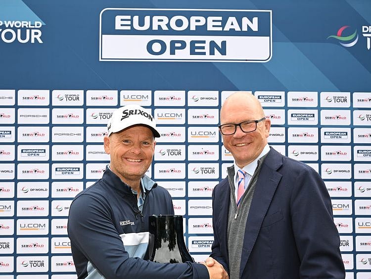 Søren Kjeldsen is presented with a gift to commemorate his 700th tournament by Guy Kinnings, the European Tour group's Chief Executive