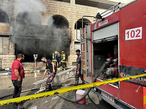 Palestinian Civil Defence members work at the central vegetables market after an Israeli raid in Ramallah in the Israeli-occupied West Bank on May 30,2024. 