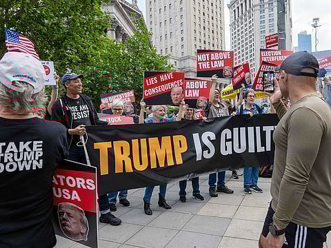 People react moments after news that former US President Donald Trump was found guilty in his trial on hush-money payments in Manhattan Criminal Court on May 30, 2024 in New York City. 