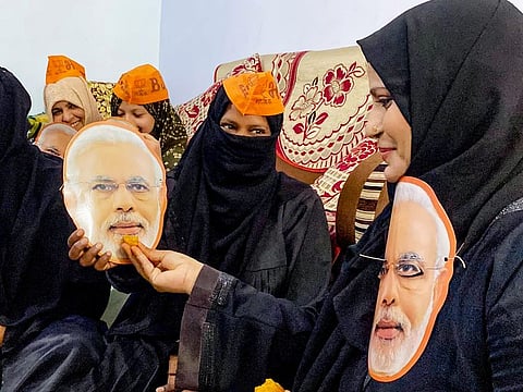 Bharatiya Janata Party supporters hold cutouts of Prime Minister Narendra Modi as they pray for his victory in Lok Sabha elections, in Prayagraj on Sunday.  