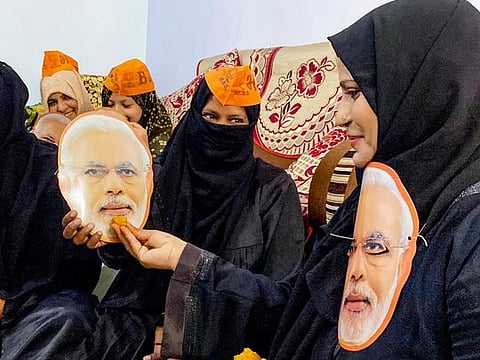 Bharatiya Janata Party supporters hold cutouts of Prime Minister Narendra Modi as they pray for his victory in Lok Sabha elections, in Prayagraj on Sunday.  