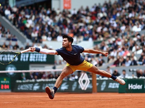 Spain's Carlos Alcaraz Garfia plays a backhand return to Canada's Felix Auger-Aliassime during their men's singles round of 16 match on Court Philippe-Chatrier at the Roland Garros Complex in Paris on June 2.