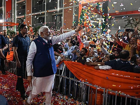 Narendra Modi, India's prime minister, greets supporters at the Bhartiya Janata Party (BJP) headquarters during election results night in New Delhi, India, on Tuesday, June 4, 2024.  