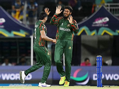 Bangladesh's vice-captain Taskin Ahmed (L) and Rishad Hossain celebrate the dismissal of Sri Lanka's Dasun Shanaka (out of frame) during the ICC men's Twenty20 Cricket  World Cup 2024 group D match at the Grand Prairie Cricket Stadium in Grand Prairie, Texas, on June 7, 2024. 