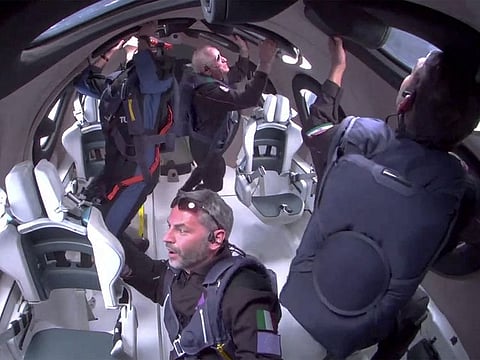 Giorgio Manenti of Italy looks out a window as Virgin Galactic's Galactic 07 mission carries four Turkish, US and Italian passengers to the edge of space and back aboard its spaceplane on a flight lasting slightly more than an hour, originating from Spaceport America near Truth or Consequences, New Mexico, on June 8, 2024 in a still image from a video.  