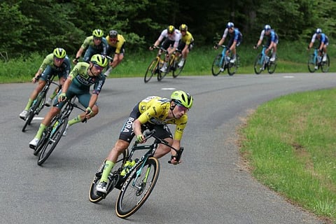 Team Bora's Slovenian rider Primoz Roglic wearing the overall leader's yellow jersey cycles with the pack of riders during the eighth and last stage of the 76th edition of the Criterium du Dauphine cycling race on Sunday.