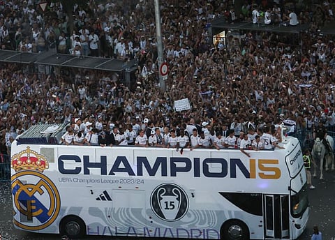 Real Madrid's players parade on their bus on Cibeles square to celebrate their 15th Champions League trophy in Madrid on June 2.