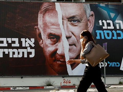 A Blue and White party election campaign banner depicting its leader, Israeli Defence Minister Benny Gantz, alongside Israeli Prime Minister Benjamin Netanyahu ahead of the March 23 ballot in 2021.  