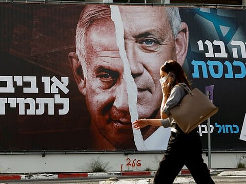 A Blue and White party election campaign banner depicting its leader, Israeli Defence Minister Benny Gantz, alongside Israeli Prime Minister Benjamin Netanyahu ahead of the March 23 ballot in 2021.  