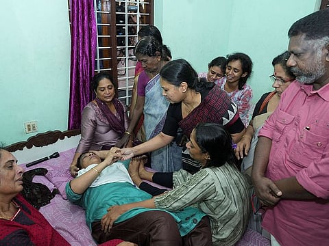 Kerala Minister for Health and Woman and Child Development Veena George consoles the mother of Akash Sasidharan Nair, one of the victims of a fire that broke out in a building housing foreign workers in Kuwait, in Pathanamthitta district in Kerala, on June 13, 2024. 