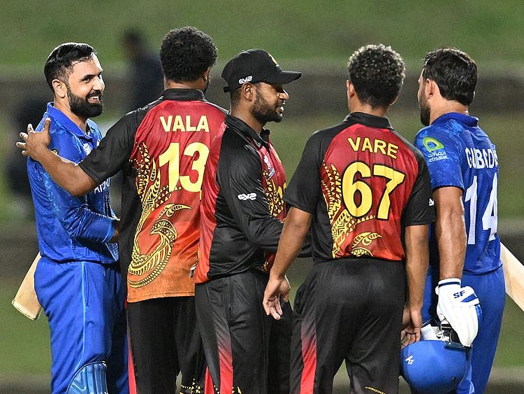 Papua New Guinea's players congratulate Afghanistan's Gulbadin Naib