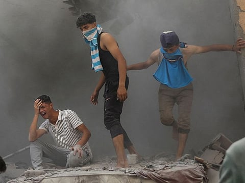 Palestinians gather at the site of an Israeli strike on a house, amid the Israel-Hamas conflict, in Deir Al Balah, in the central Gaza Strip, June 14, 2024.