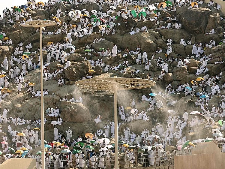 Mist dispensers refreshen pilgrims as they walk up Saudi Arabia's Mount Arafat, also known as Mount of Mercy, during the Hajj pilgrimage on June 15, 2024. 