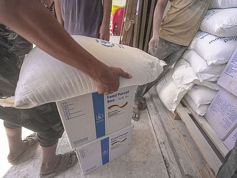 Food aid is distributed in Deir Al Balah, Gaza as part of a World Food Programme operation.