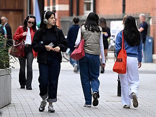 Students make their way around the London School of Economics campus, in central London.