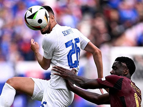 Slovakia's forward #26 Ivan Schranz (L) jumps for the ball next to Belgium's midfielder #18 Orel Mangala  during the UEFA Euro 2024 Group E football match between Belgium and Slovakia at the Frankfurt Arena in Frankfurt am Main on June 17, 2024.