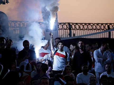 Turkey fans celebrate with flares after the match