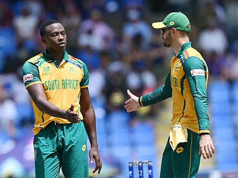 South Africa's Kagiso Rabada (L) celebrates the dismissal of USA's Harmeet Singh during the ICC men's Twenty20 Cricket World Cup 2024 Super Eight match against United States at Sir Vivian Richards Stadium in North Sound, Antigua and Barbuda on June 19, 2024. 