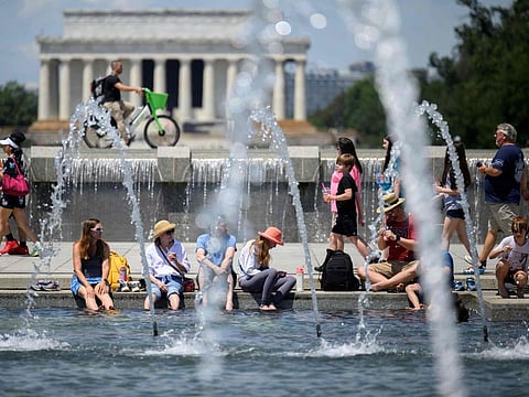 Americans cool off at the US World War II Memorial in Washington, DC, on June 19, 2024. Extreme heat and high humidity smothered the central and northeastern United States, with temperature records expected to melt away in the coming days, authorities warned, as wildfires sizzled in the west.  