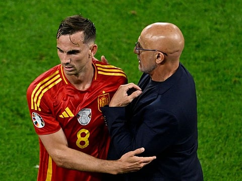 Spain's head coach Luis de la Fuente greets midfielder Fabian Ruiz (left) after winning the Uefa Euro 2024 Group B match against Italy.